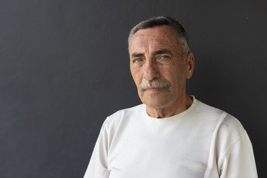 portrait of serious elderly senior man  looking at camera