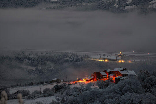 Winter dawn over a mountain village and valley