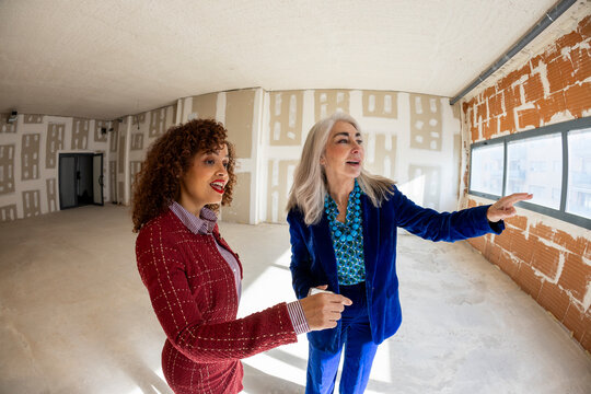 Realtor agent showing empty commercial space to potential client