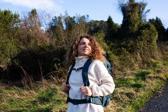 Woman enjoying hiking in nature carrying backpack