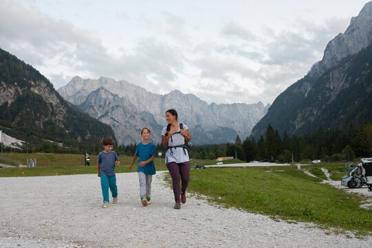 Two Children and a Parent Walk on a Path in the Mountains, Slovenia