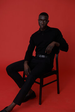 Black man in suit posing in studio