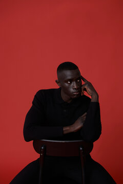 Black man in suit posing in studio