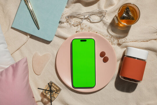 Cozy self-care routine with blankscreen phone, tea, and beauty tools