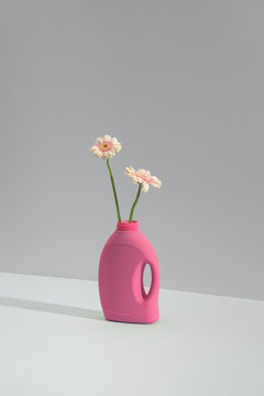 Minimalist still life of a pink repurposed bottle used as a vase