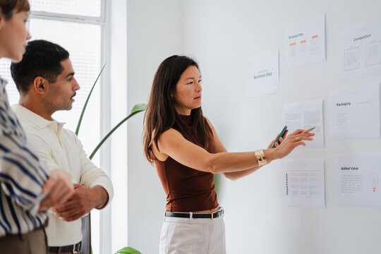 Woman is delivering a briefing to her team