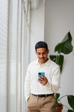 Businessman uses his phone indoors