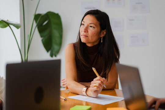 Focused woman sits in a meeting room