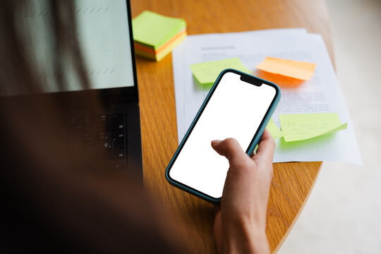 Anonymous woman scrolls on a smartphone