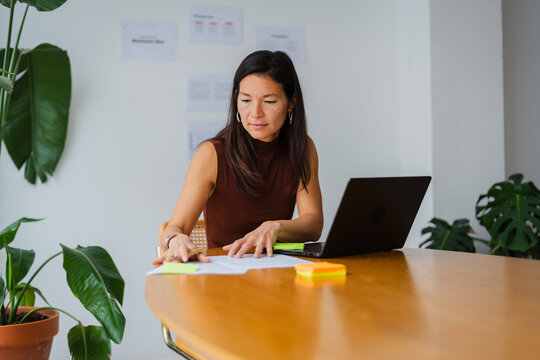 Busy woman works at her desk