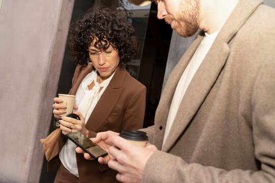 Coworkers Checking Phone Together