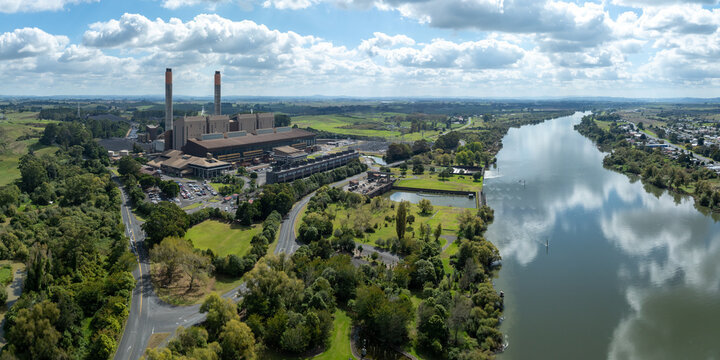 HUNTLY,  NEW ZEALAND: 7 April 2026 - Huntly Power Station, a thermal power plant in Huntly, New Zealand, emits steam into the sky on a cloudy day, showcasing industrial power generation.