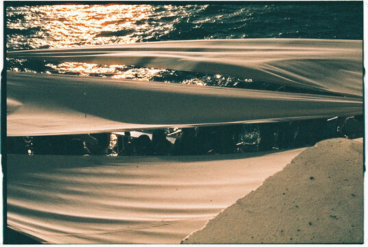 Sunlit ocean surface seen beneath a fabric canopy in Madeira