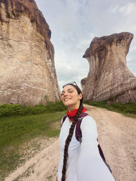 woman taking selfie among weird looking rocks