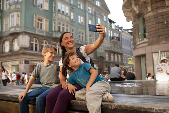Family Enjoys Selfie Time in City Square During Sunny Afternoon
