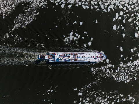 Aerial view of ship breaking ice on river
