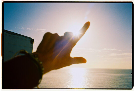 Hand Reaching for Sun