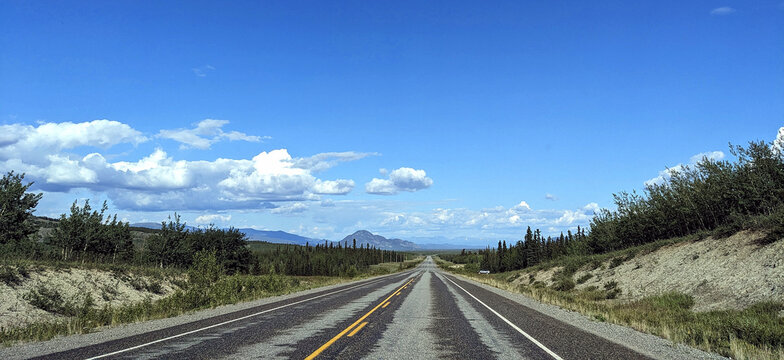 Flat Yukon highway that has very few vehicles even in the summer. YT, Canada