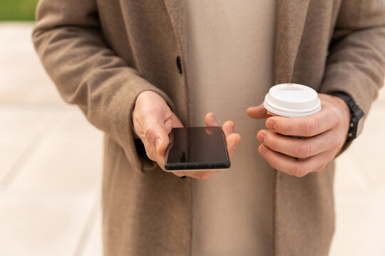 Hands Holding Phone And Coffee