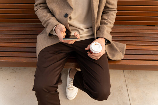 Man Using Phone On Bench