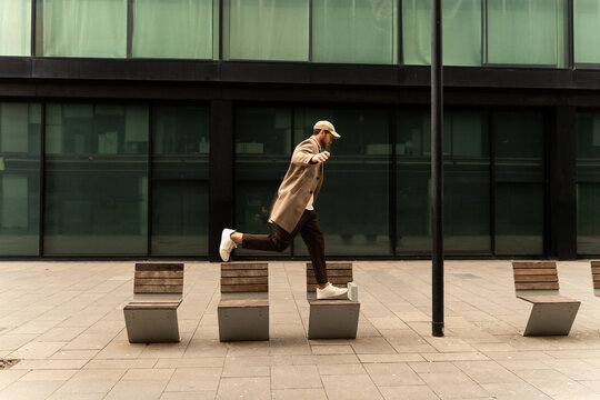 Man Jumping Urban Benches