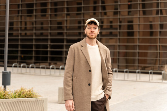 Casual Man Stands Outside Modern Building 