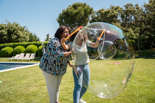 Bubble play in a sunny backyard setting