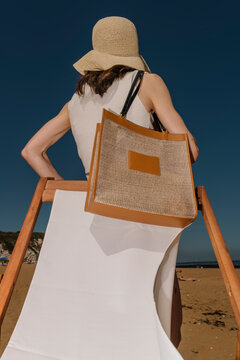 Beachside Relaxation With Straw Hat And Tote Bag