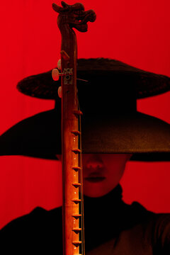 Fashion woman holding a traditional Chinese musical instrument,closeup