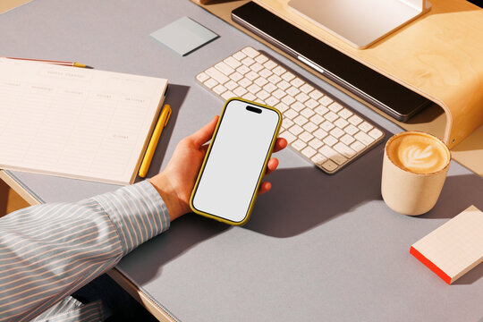 Smartphone mockup with white screen in business workspace