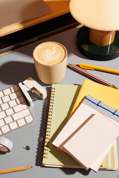 Business office desk with coffee and stationery items