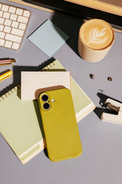 Business office desk with smartphone and coffee cup