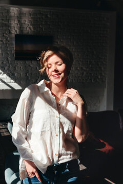 Warm Sunlight Dances on a Smiling Woman in a Cozy Room