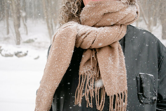 snowy scarf on women in snowstorm