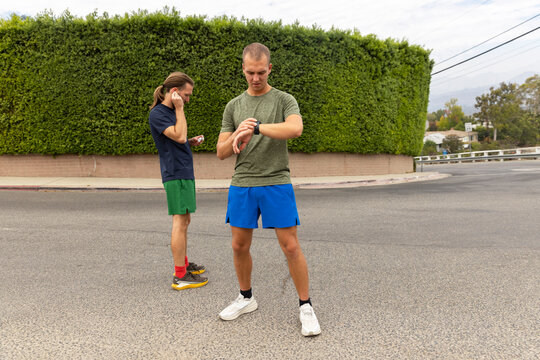 Men Running road Los Angeles city check smart watch
