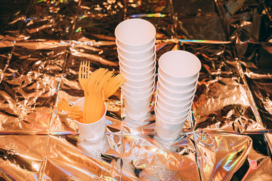 Cups and forks on shiny table surface