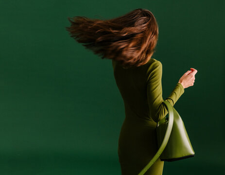 Green Dress and Bag in Motion