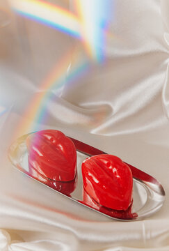 Red lip shaped desserts with rainbow light