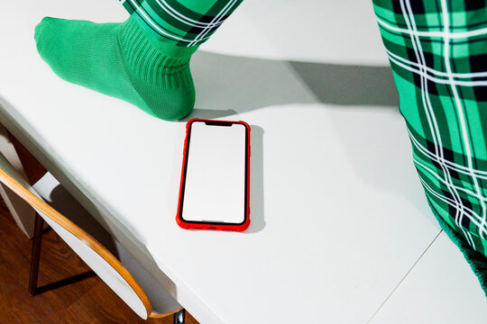 a blank smartphone screen near a table edge