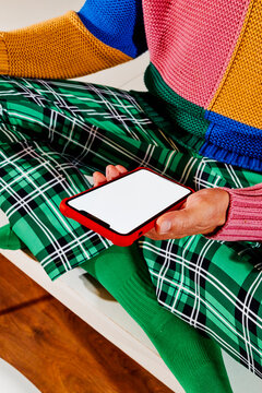a man holds a smartphone with a blank white screen