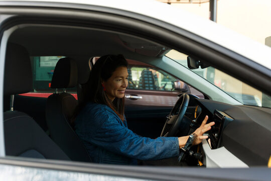 Woman Driving a Car in a Busy Area