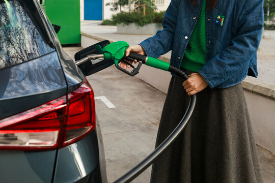 Woman Fueling Car at Gas Station 