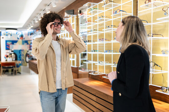 Man trying on new eyeglasses in optical shop