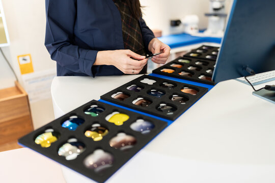 Pregnant optometrist choosing trial lenses for vision correction