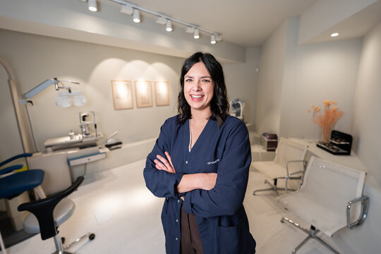 Smiling optometrist doctor working in an optical shop