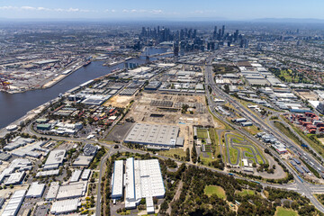port melbourne aerial view suburban industrial area city skyline warehouses transportation roads river commercial properties construction site green spaces melbourne victoria australia © Brett Price