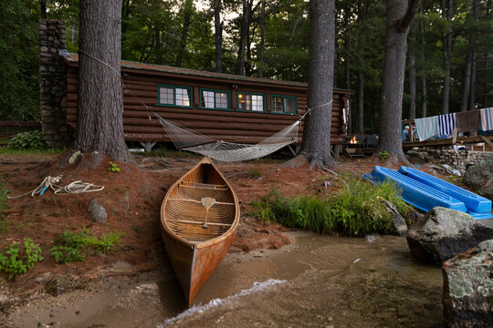 Log Cabin with wooden canoe Summer Maine