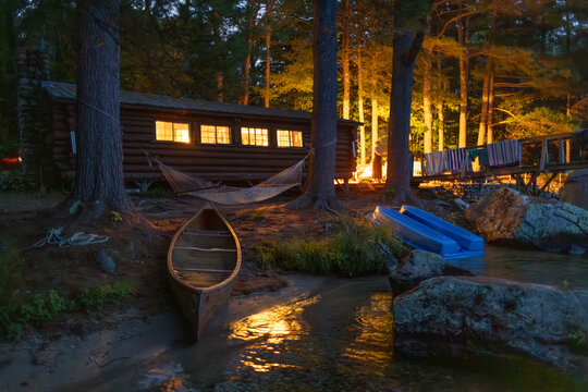 Log Cabin Lake Maine with wooden canoe Summer 