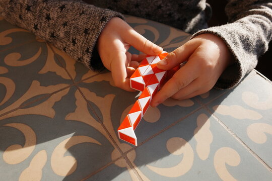 Child Playing With a Colorful Building Toy