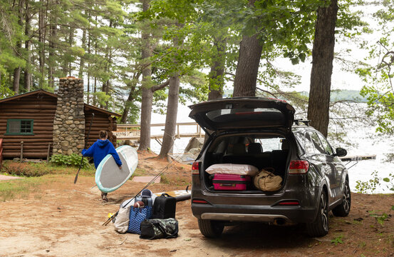 Woman Paddleboard car Maine log cabin